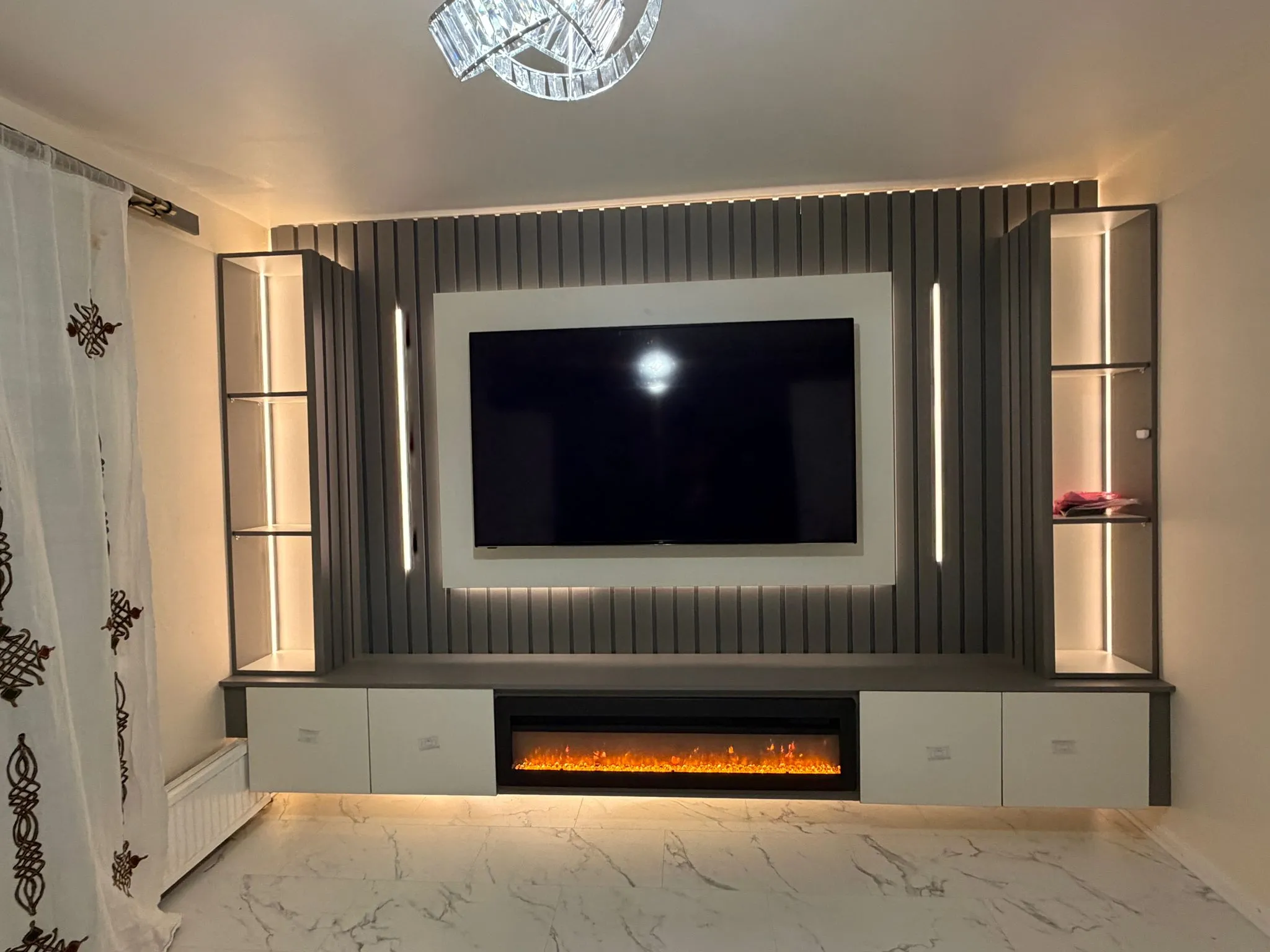 Bespoke Space media wall featuring a 3-sided panoramic electric fireplace and floating hearth.