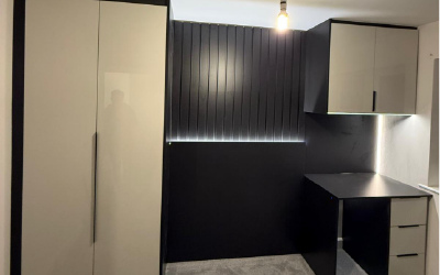 Minimalist slab-door wardrobes with push-to-open technology by Bespoke Space.