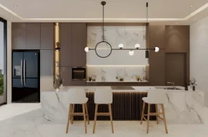 Modern kitchen island with architectural pendant lighting and LED plinth lights.